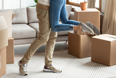 Couple embracing with moving boxes