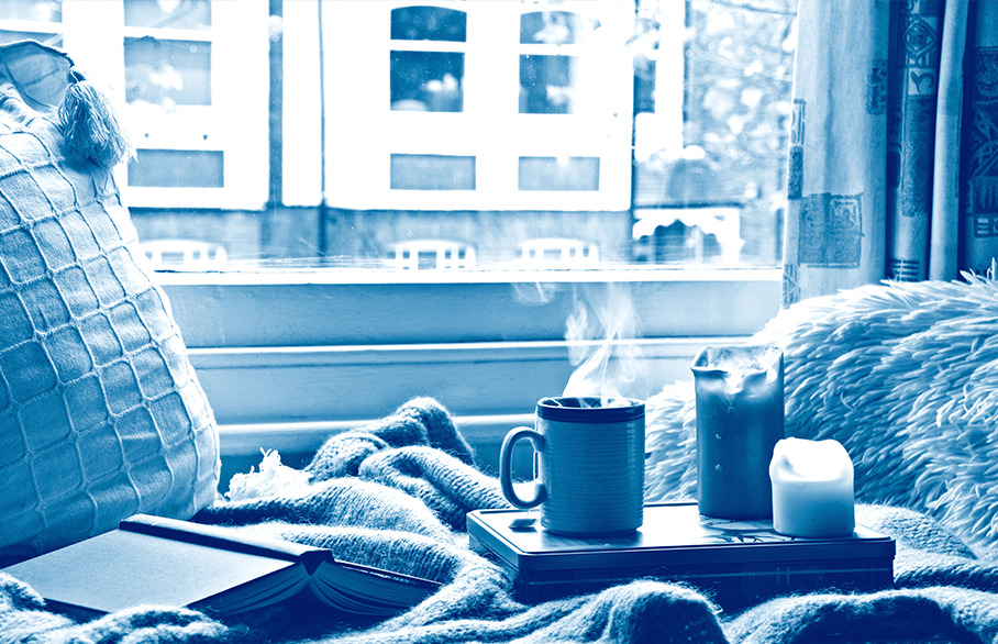 Hot drink with candles and book