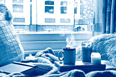 Hot drink with candles and book