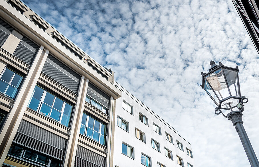 Building, lamp post, clouds in the sky