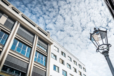 Building, lamp post, clouds in the sky