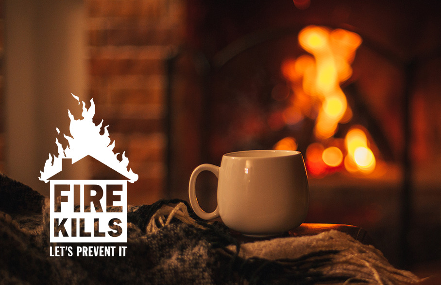 Mug in front of fire with Fire Kills logo