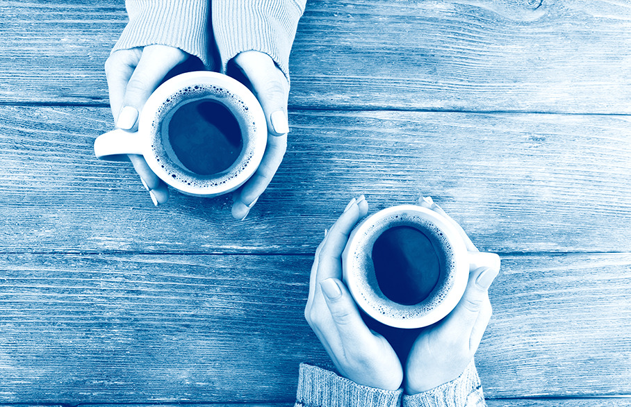 Two pairs of hands holding warm mugs, blue wash