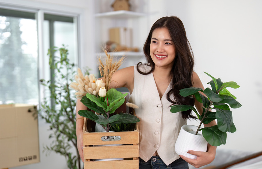 woman on moving day with box and plant