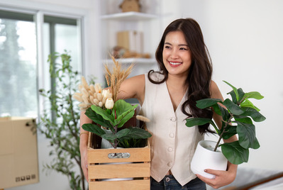 woman on moving day with box and plant