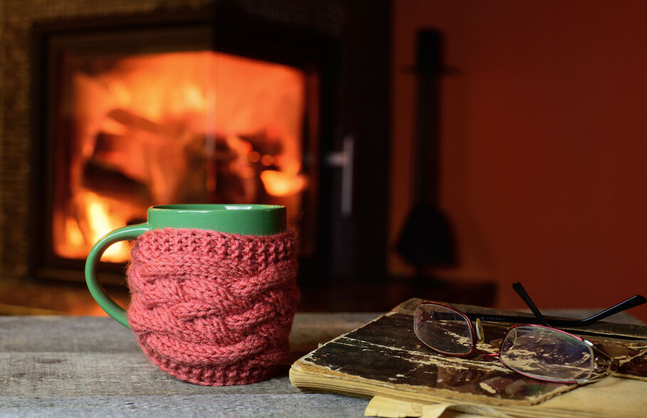Warm mug by the fireplace in a cosy home