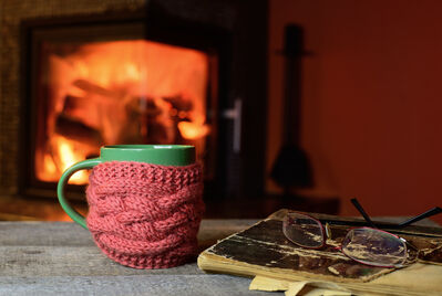 Warm mug by the fireplace in a cosy home