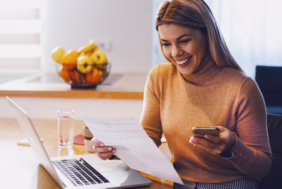 Woman looking happily at her phone