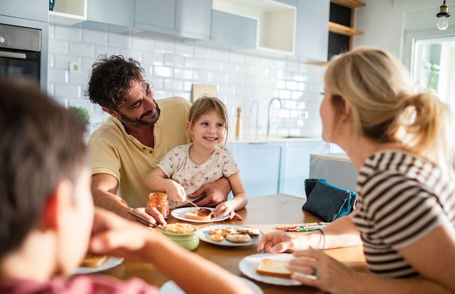 family having breakfast at the table at home