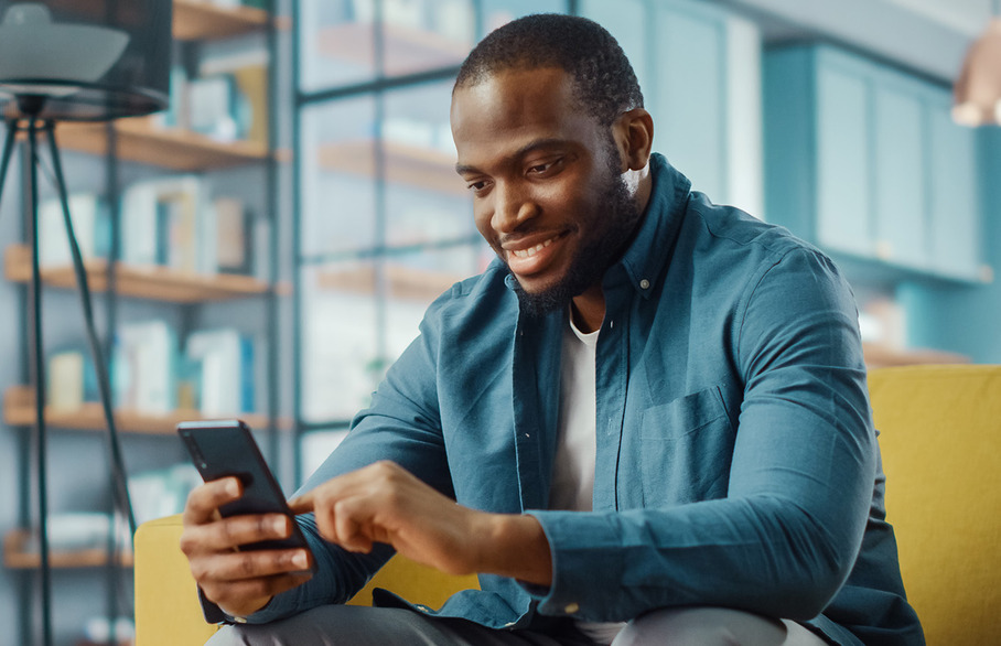 Man looking at his phone smiling