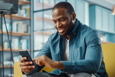Man looking at his phone smiling