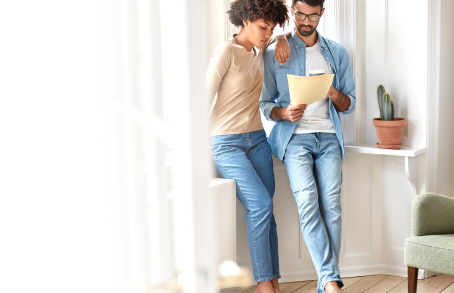 Two people stood up looking at paperwork