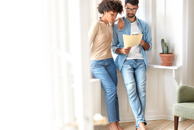 Two people stood up looking at paperwork