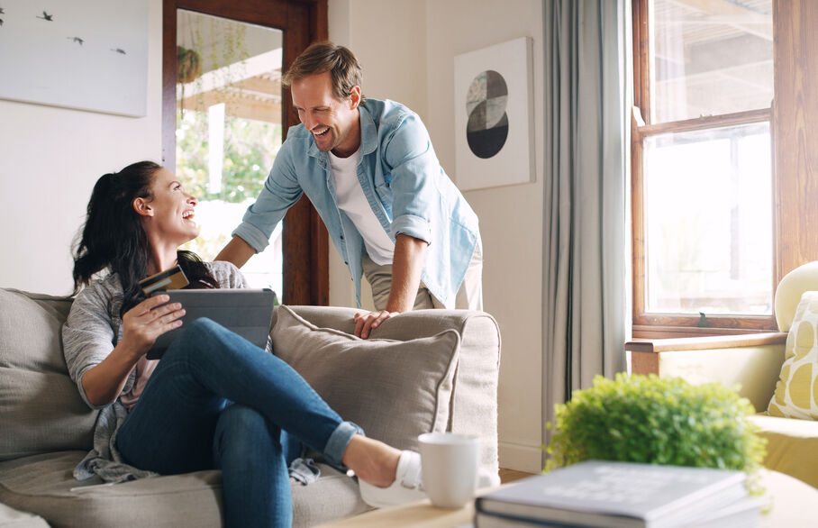 A couple smiling at each other in the living room