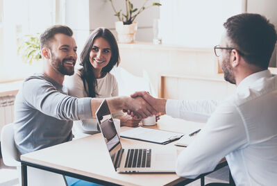 couple shaking hands with man