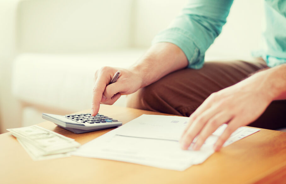 Person using a calculator and writing notes