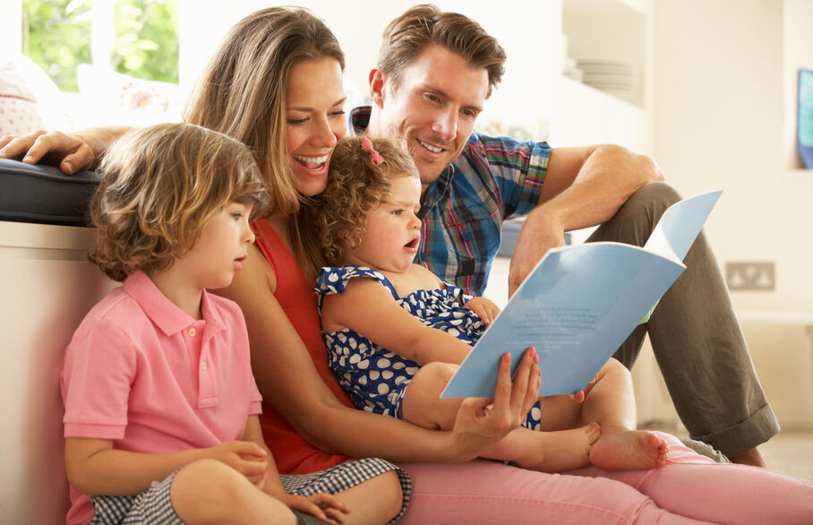 Family looking at a book