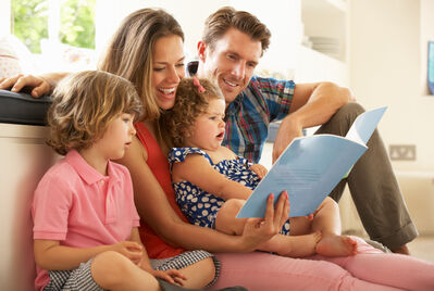 Family looking at a book