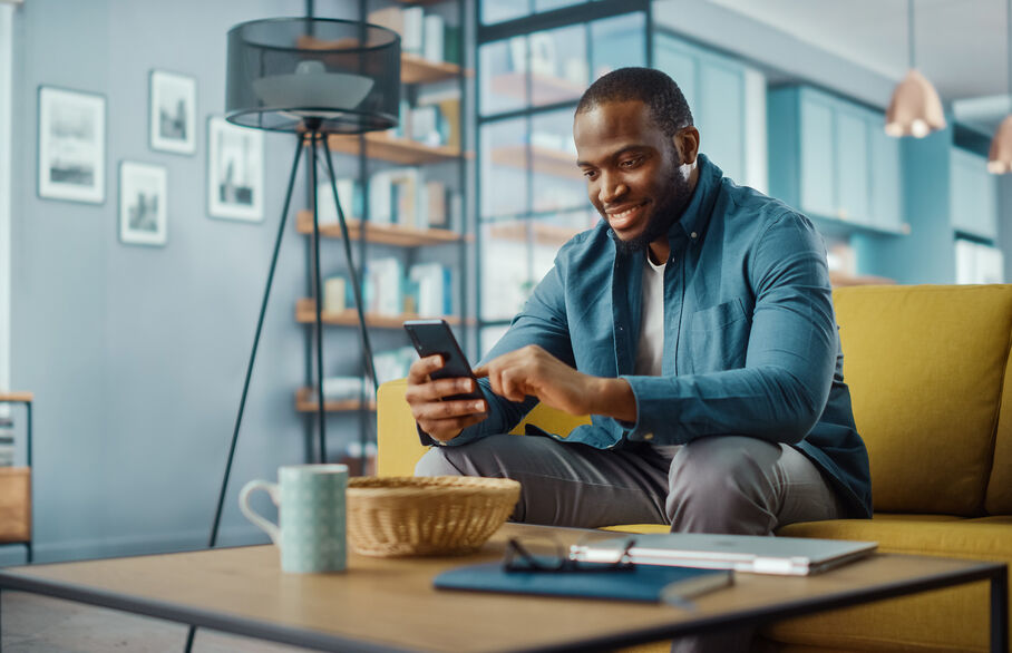 Person sitting on sofa looking at phone