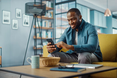 Person sitting on sofa looking at phone