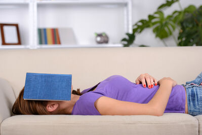 women with book over her head