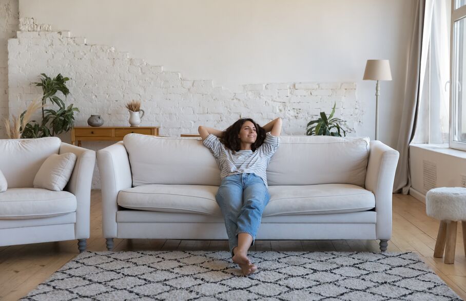 Lady sat on a sofa at home
