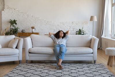 Lady sat on a sofa at home