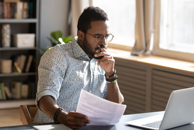 man looking at paper work