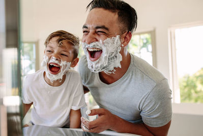 Father and son having fun while shaving