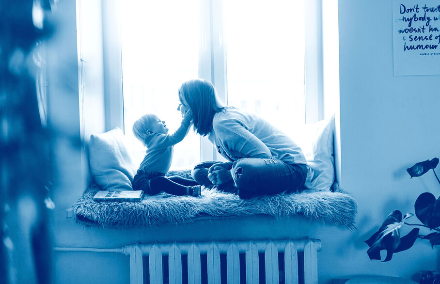 Mum and baby sitting at the window sill