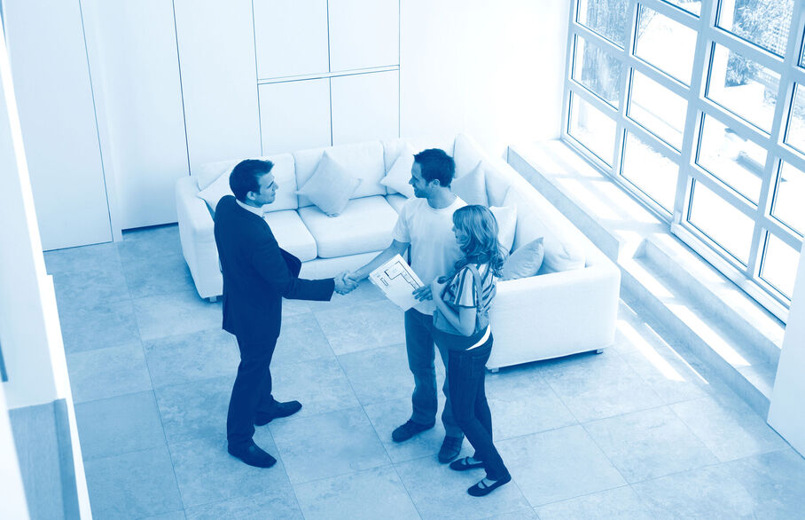 Couple shaking hands with an agent