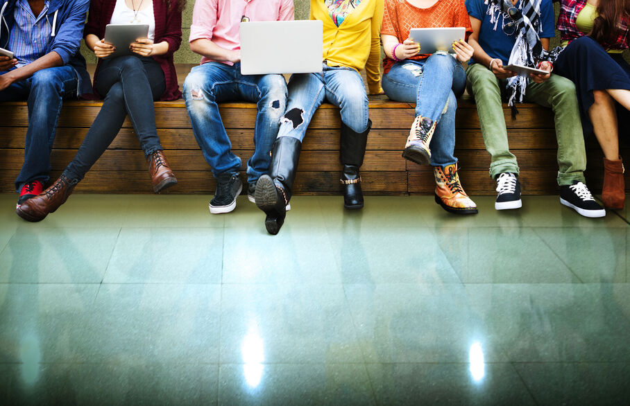 Row of people sat on a wall