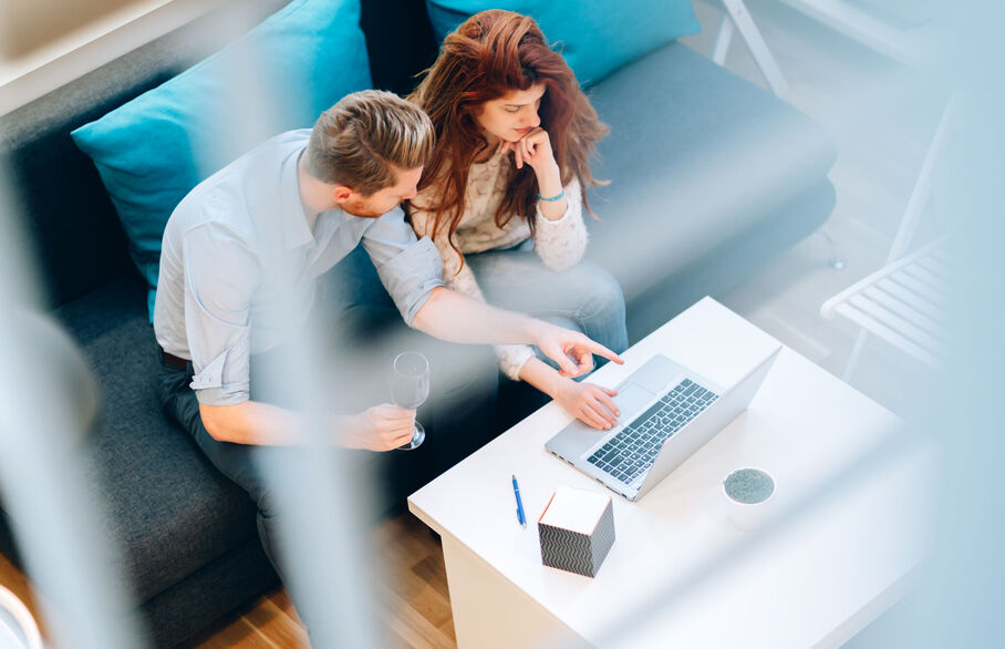 Couple sat in front of their laptop