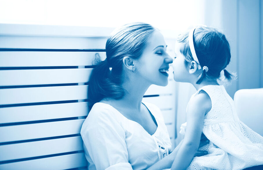 Mum touching noses with little girl