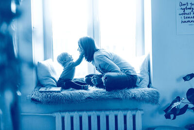 Mother and child sat on a window seat