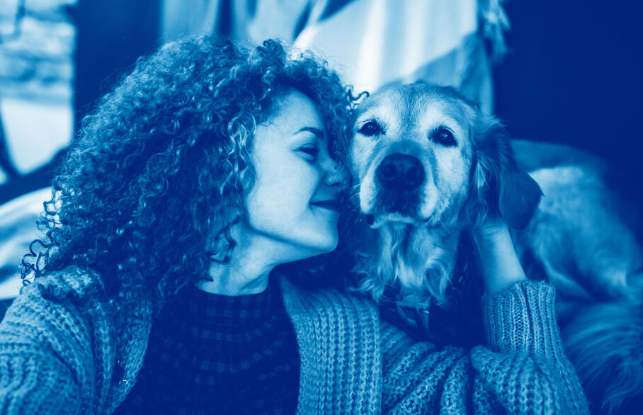 Lady cuddling her dog