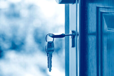 Keys in the lock of an open door