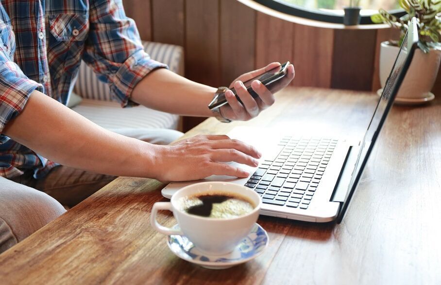 Man with phone and laptop