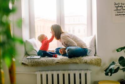 Parent with a child sat in a window seat