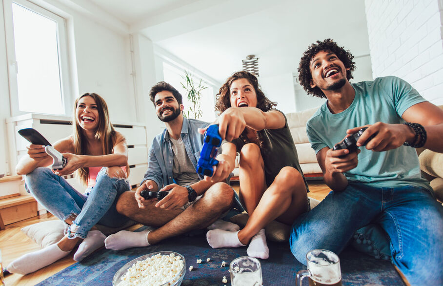 People gaming and sat looking at a TV