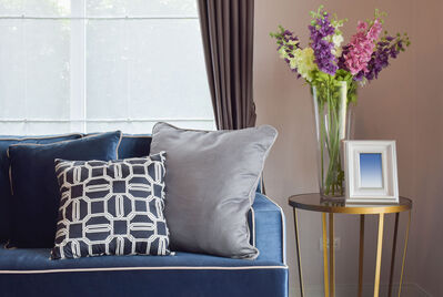 Photo of a living room with sofa and spring flowers