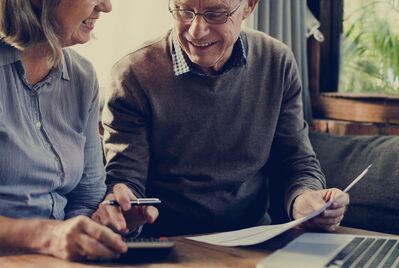 People looking at paperwork and a phone