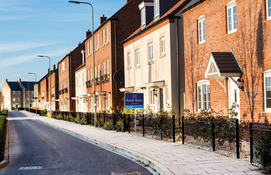 Row of houses with a To Let board outside