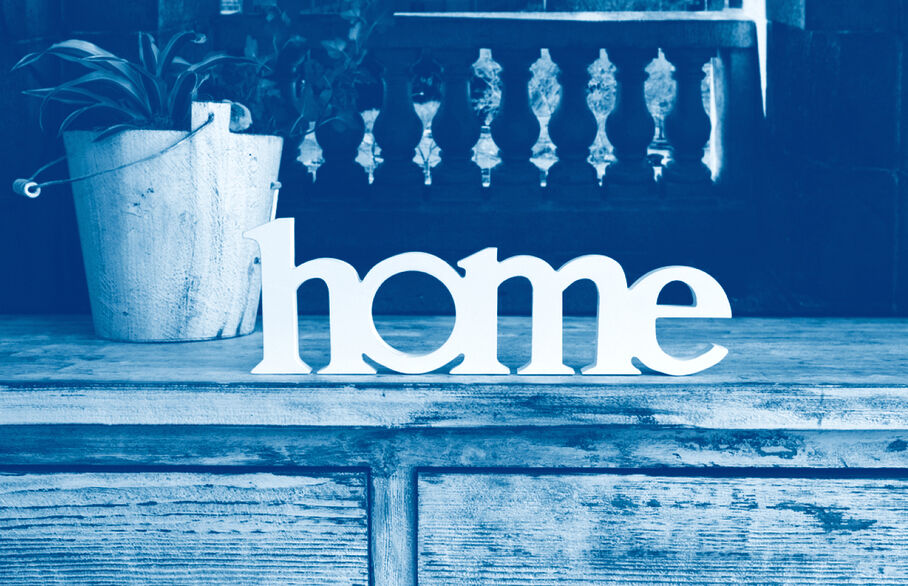 Picture of the word home on a sideboard