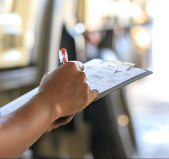 A letting agent showing two landlords a laptop